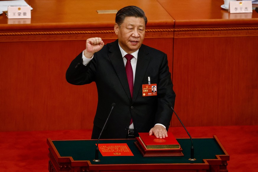 epa10512846 Chinese President Xi Jinping takes his oath during the Third Plenary Session of the National People&#039;s Congress (NPC) at the Great Hall of the People, in Beijing, China, 10 March 2023. ...