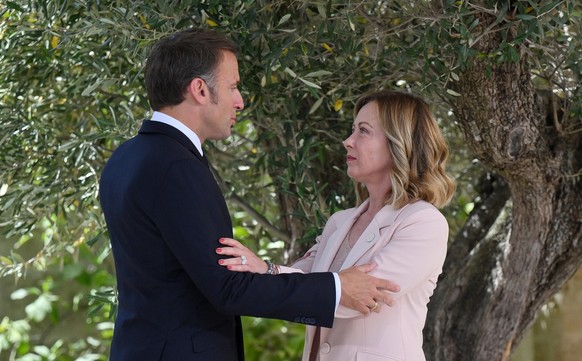 epa11407586 Italy's Prime Minister Giorgia Meloni (R) greets French President Emmanuel Macron (L) during a welcome ceremony for the G7 summit in Borgo Egnazia, southern Italy, 13 June 2024. The 5 ...