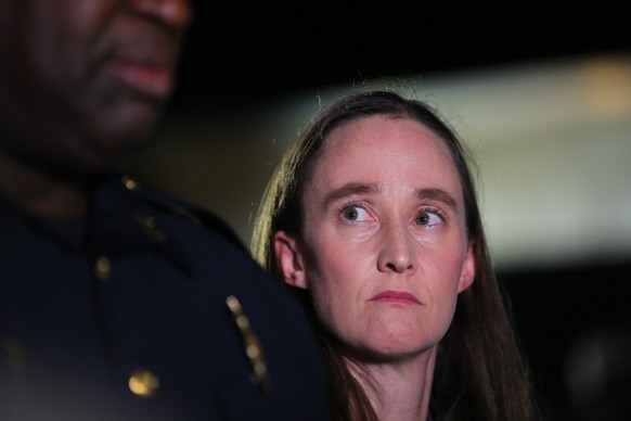 epa13135244 Seattle Mayor Katie Wilson listens as Assistant Chief of Special Operations for the Seattle Police Department Tyrone Davis speaks to the media at the scene after a fatal shooting during th ...
