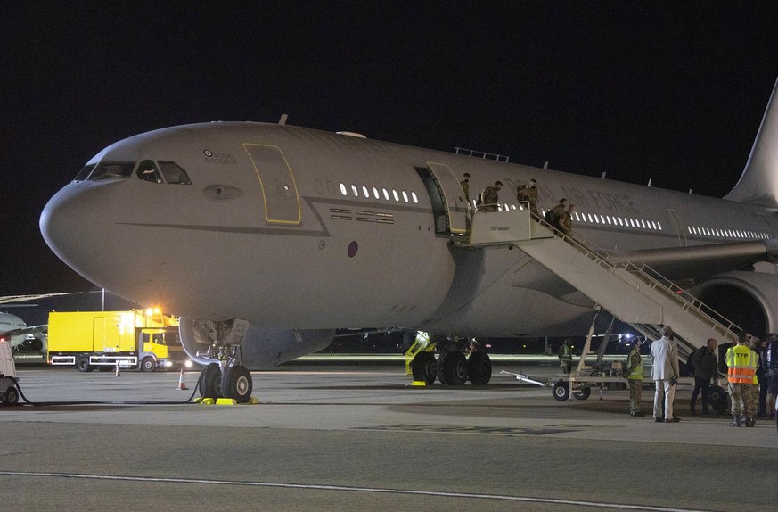In the photo provided by the Ministry of Defence, the first flight carrying evacuated personnel of British Embassy staff and British Nationals, arriving at RAF Brize Norton, England, early Monday Aug. ...