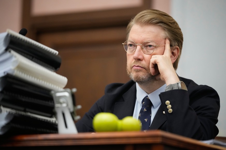 Yabloko party leader Nikolai Rybakov attends a hearing to appeal a lawsuit to bar the party from the upcoming parliamentary elections, at the Russia's Supreme Court, in Moscow, Monday, Aug. 17, 2 ...