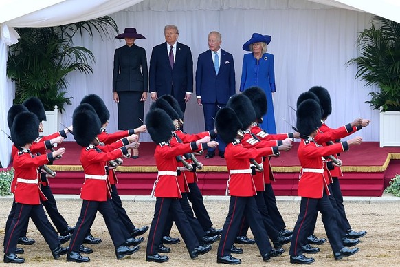 WINDSOR, ENGLAND - SEPTEMBER 17: First Lady Melania Trump, U.S. President Donald Trump, King Charles III and Queen Camilla inspect the troops during the State visit by the President of the United Stat ...
