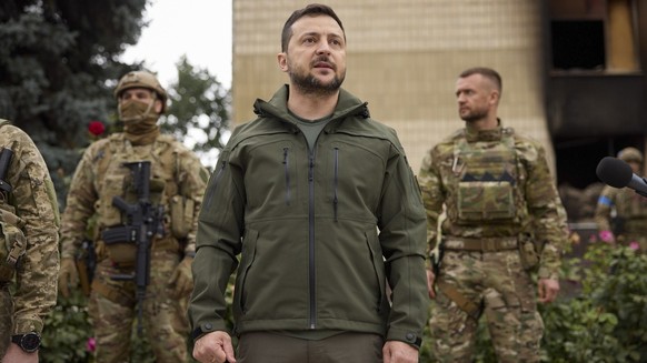 A handout photo made available by the presidential press service shows Ukrainian President Volodymyr Zelensky attends a ceremony of the National flag rising in the reclaimed city of Izyum in Kharkiv&# ...