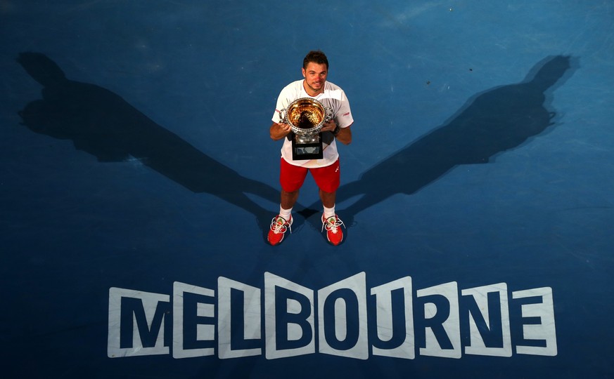 Stanislas Wawrinka of Switzerland holds the trophy after defeating Rafael Nadal of Spain in the men's singles final at the Australian Open tennis championship in Melbourne, Australia, Sunday, Jan ...