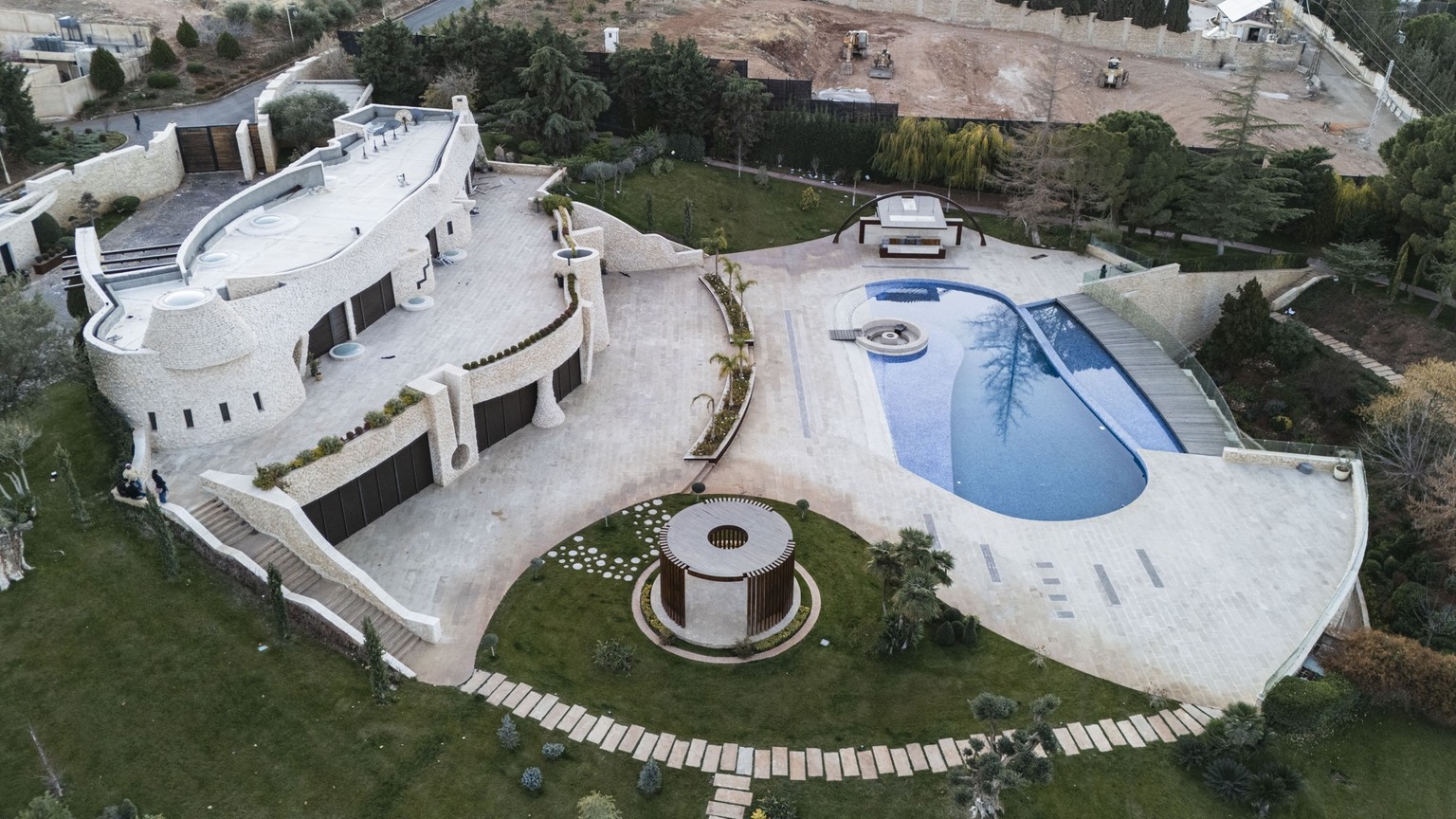 (FILES) This aerial picture shows the villa of Maher al-Assad, the brother of the ousted Syrian president Bashar al-Assad, in the town of Yafour near Damascus on December 23, 2024. Many bases of Syria ...