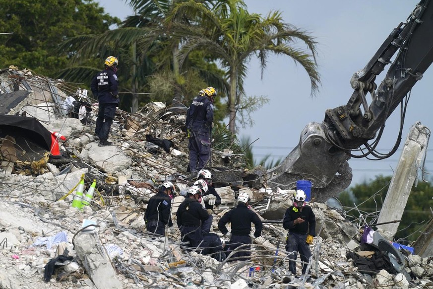 Rescue crews work at the site of the collapsed Champlain Towers South condo building after the remaining structure was demolished Sunday, in Surfside, Fla., Monday, July 5, 2021. Many people are unacc ...