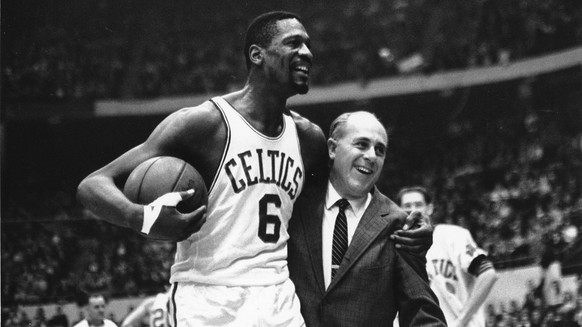 FILE - Bill Russell, left, star of the Boston Celtics is congratulated by coach Arnold &quot;Red&quot; Auerbach after scoring his 10,000th point in the NBA game against the Baltimore Bullets in Boston ...