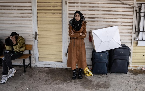 epa11772591 A Syrian woman waits to cross into Syria from Turkey at the Oncupinar border gate, near the town of Kilis, southern Turkey, 12 December 2024. The Political Affairs Department of the Syrian ...