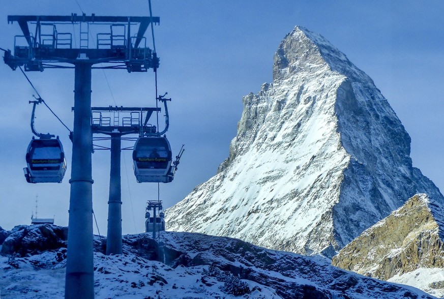 Gondolas go up next to the Matterhorn in Zermatt, Switzerland, Thursday, Dec.3, 2020. Zermatt is home to one of the Swiss ski stations that has become an epicenter of discord among Alpine neighbors. E ...