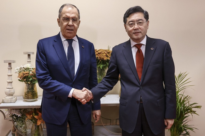 In this handout photo released by Russian Foreign Ministry Press Service, Russian Foreign Minister Sergey Lavrov, left, and Chinese Foreign Minister Qin Gang pose for photo on the sideline of G20 fore ...