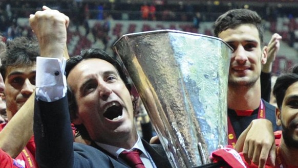 Sevilla&#039;s head coach Unai Emery holds the trophy after Sevilla won 3-2 during the final of the soccer Europa League between FC Dnipro Dnipropetrovsk and Sevilla FC at the National Stadium in Wars ...