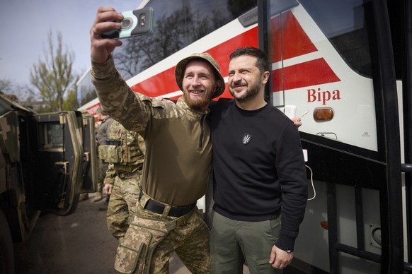 epa10578657 A handout photo made available by Ukraine&#039;s Presidential Press Service shows Ukraine&#039;s President Volodymyr Zelensky (R) posing for a photo with a Ukrainian serviceman during a wo ...