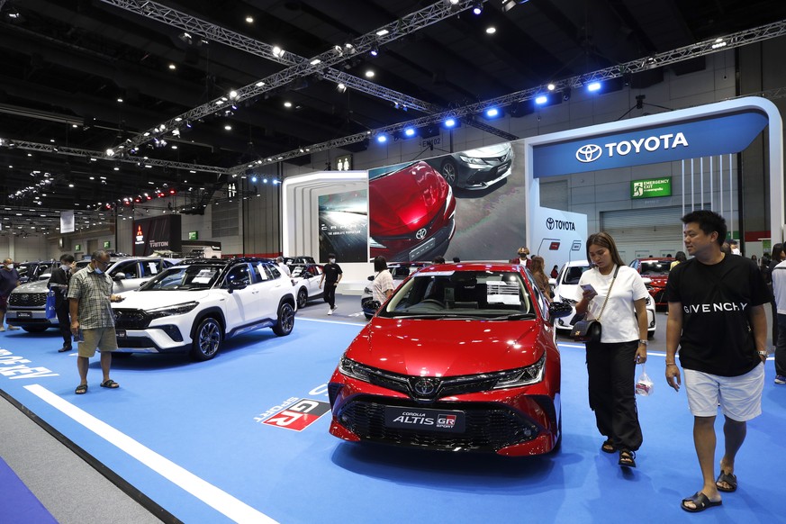 epa10825020 Visitors look at Toyota cars displayed at the Big 2023 Motor Sale, an automotive trade event in Bangkok, Thailand, 28 August 2023. The number of new car sales in July 2023 has dropped 8.77 ...