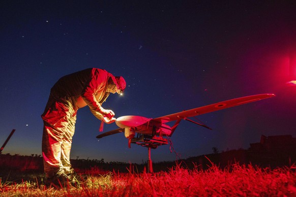 A Ukrainian National Guard serviceman of 3rd brigade, Spartan, prepares a Penguin UAV for flight near the frontline in Pokrovsk direction, Ukraine, Wednesday, Aug. 6, 2025. (AP Photo/Evgeniy Maloletka ...