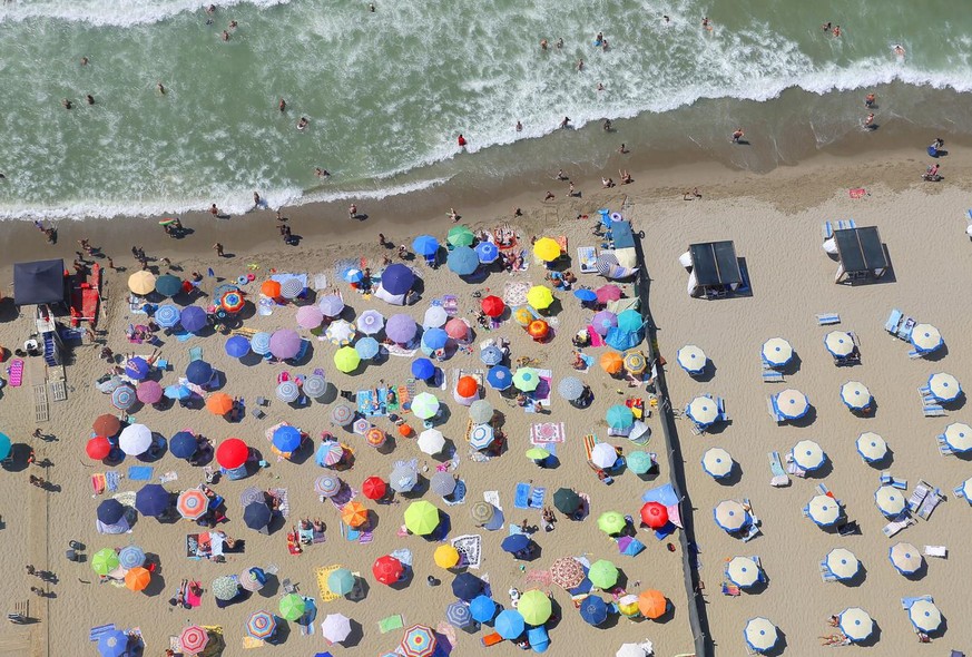 epa08605811 An aerial view of Tirrenia beach, with free access seaside on left, Pisa, Italy, 15 August 2020, during a flyover with HH-412C Volpe 220 helicopter of the Aerial Section of the Italian Fin ...