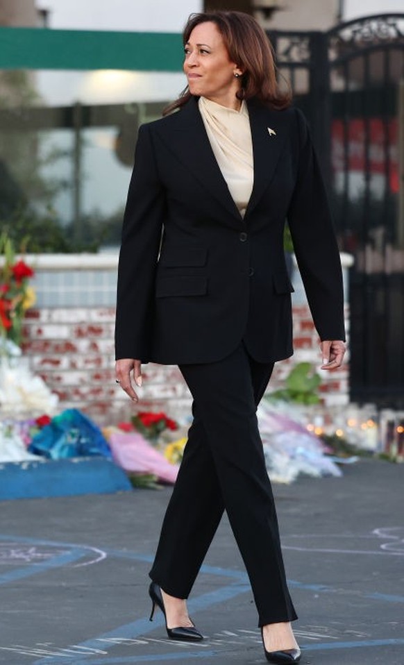 MONTEREY PARK, CALIFORNIA - JANUARY 25: U.S. Vice President Kamala Harris walks after placing flowers at the memorial outside the Star Ballroom Dance Studio where a deadly mass shooting took place on  ...