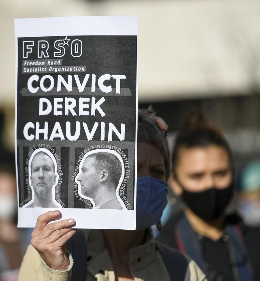 epa09062359 Protesters gather near the the Hennepin County Government Center as jury selection was to begin in the trial of former officer Derek Chauvin in the killing of George Floyd, Minnesota, USA, ...