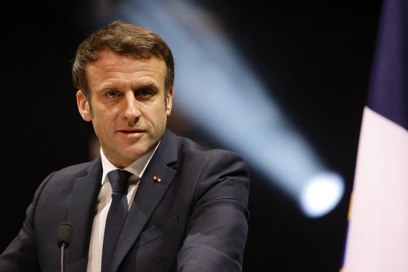 French President Emmanuel Macron delivers his speech during a tribute ceremony for victims of the 2012 attacks, at the Halle aux Grains in Toulouse, southwestern France, Sunday, March 20, 2022. French ...