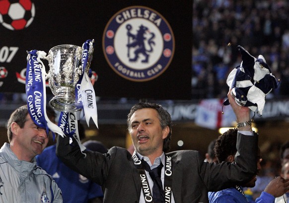 Chelsea&#039;s coach Jose Mourinho reacts as he holds the English League Cup after defeating Arsenal 2-1 in the final soccer match at the Millennium Stadium in Cardiff, Wales, Sunday, Feb. 25, 2007. ( ...