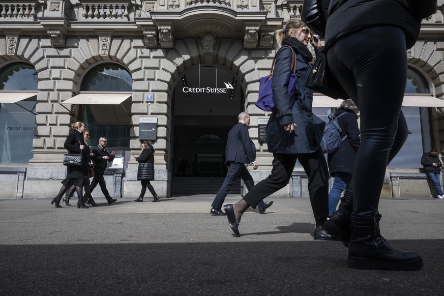 People walk past the entrance of Swiss bank Credit Suisse at their headquarters in Zurich, Switzerland 16 March 2023. Credit Suisse is borrowing up to 50 billion francs (50.8 billion euros) from the S ...
