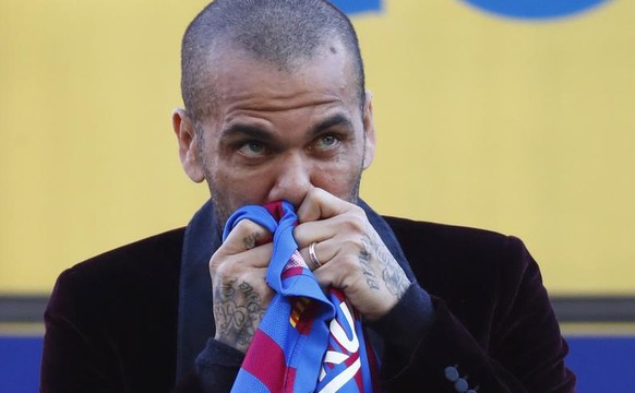 Dani Alves kisses a team shirt during his official presentation for FC Barcelona in Barcelona, Spain, Wednesday, Nov. 17, 2021. Veteran full back Dani Alves has returned to Barcelona at age 38 to fini ...