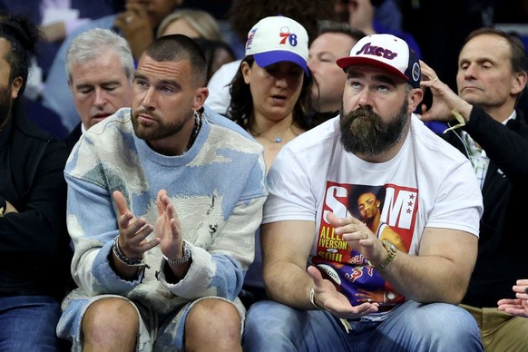 PHILADELPHIA, PENNSYLVANIA - MAY 11: (L-R) Travis Kelce of the Kansas City Chiefs and Jason Kelce of the Philadelphia Eagles watch game six of the Eastern Conference Semifinals in the 2023 NBA Playoff ...