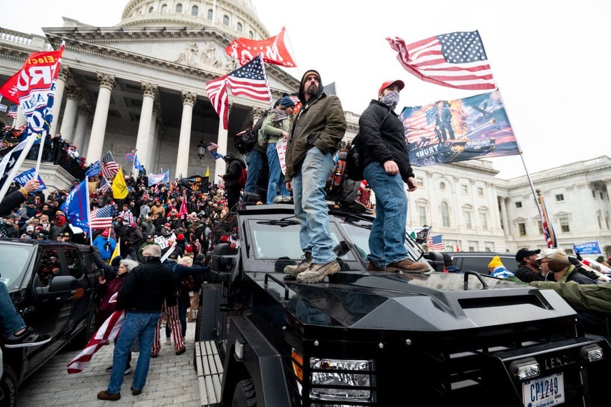 UNITED STATES - JANUARY 6: Trump supporters stand on the U.S. Capitol Police armored vehicle as others take over the steps of the Capitol on Wednesday, Jan. 6, 2021, as the Congress works to certify t ...