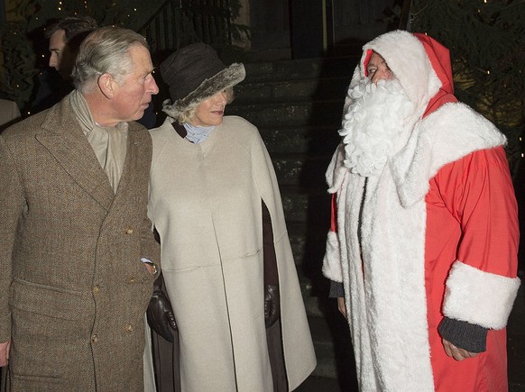 TETBURY, ENGLAND - DECEMBER 07: Prince Charles, Prince of Wales and Camilla, Duchess of Cornwall meet Father Christmas as they switch on the Christmas lights on December 7, 2012 in Tetbury, England. ( ...