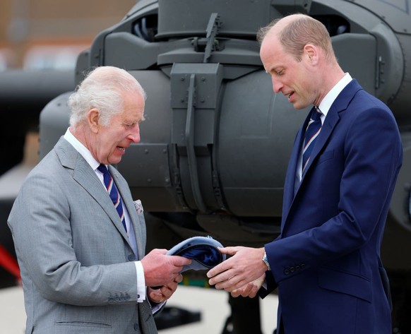 STOCKBRIDGE, UNITED KINGDOM - MAY 13: (EMBARGOED FOR PUBLICATION IN UK NEWSPAPERS UNTIL 24 HOURS AFTER CREATE DATE AND TIME) King Charles III presents Prince William, Prince of Wales (both wearing the ...