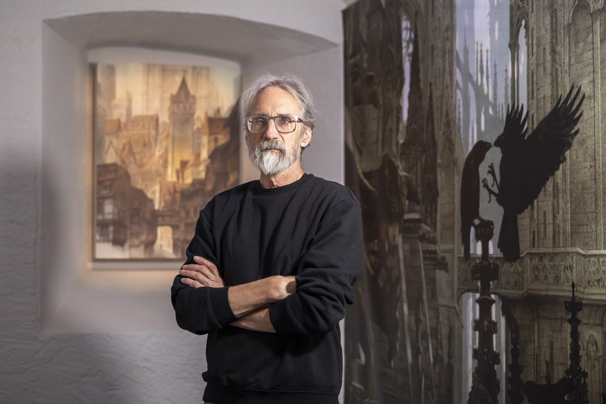 epa12593999 John Howe, Canadian artist and illustrator, poses for a photograph during the inaugural exhibition of 'Journey into the Worlds of John Howe' at the Tour du Fantastique in Neuchat ...