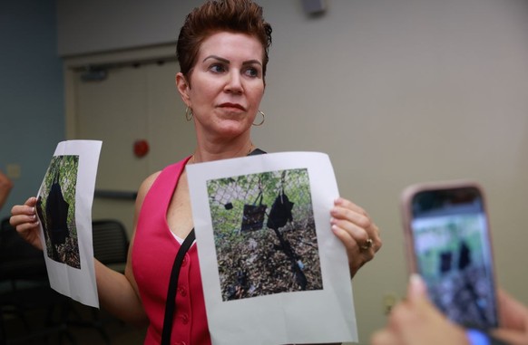 WEST PALM BEACH, FLORIDA - SEPTEMBER 15: Palm Beach County Sheriff PIO Teri Barber holds photographs of the rifle and other items found near where a suspect was discovered during a press conference re ...