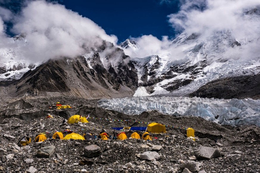 GORAKSHEP, SOLU KHUMBU, NEPAL - 2019/09/15: Tents set up at Everest Base Camp on Khumbu glacier, Mt. Everest behind covered by monsoon clouds. (Photo by Frank Bienewald/LightRocket via Getty Images)