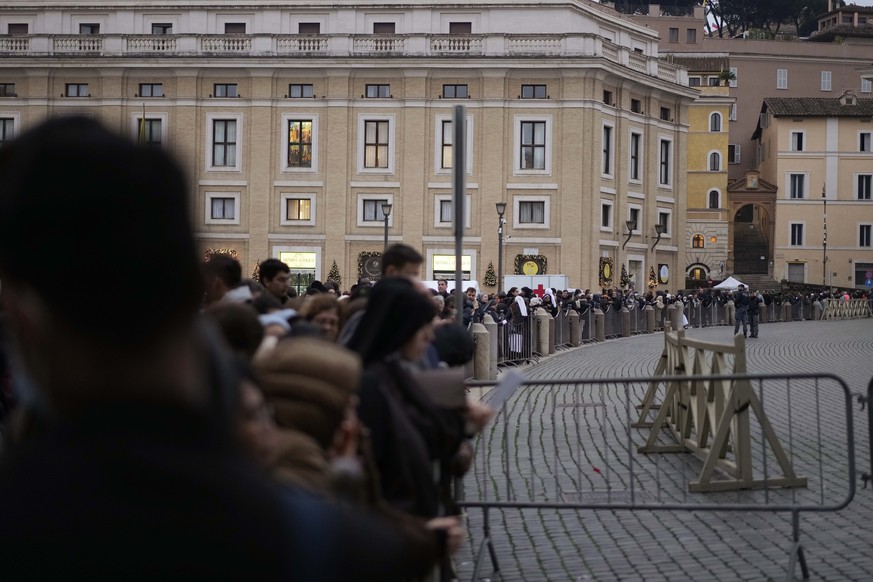 People wait in a line to enter Saint Peter's Basilica at the Vatican where late Pope Benedict 16 is being laid in state at The Vatican, Monday, Jan. 2, 2023. Benedict XVI, the German theologian w ...