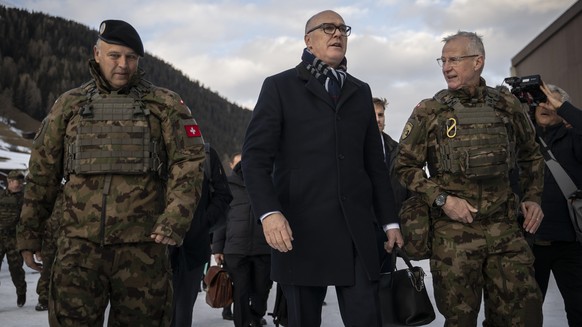epa12661829 Switzerland's Minister for Defense, Civil Protection and Sport Martin Pfister (C), and Benedikt Roos (L), Chief of the armed forces, with Division Commander Maurizio Dattrino (R) visi ...