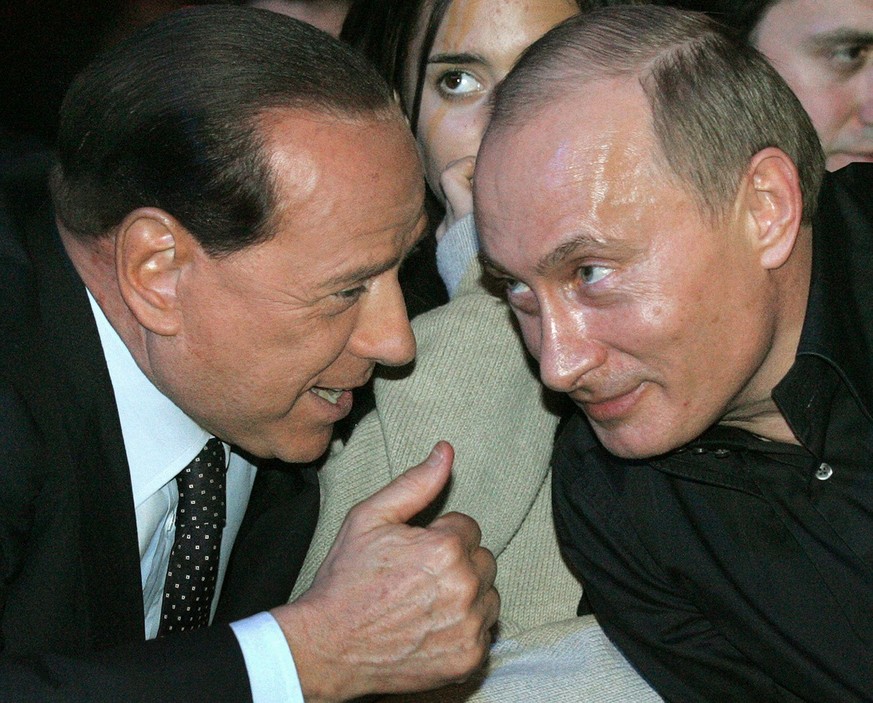 Russian President Vladimir Putin and former Italian Prime Minister Silvio Berlusconi, from right, attend the Mixed Fighting Championships between Russia and USA at the Ledovy stadium in St. Petersburg ...