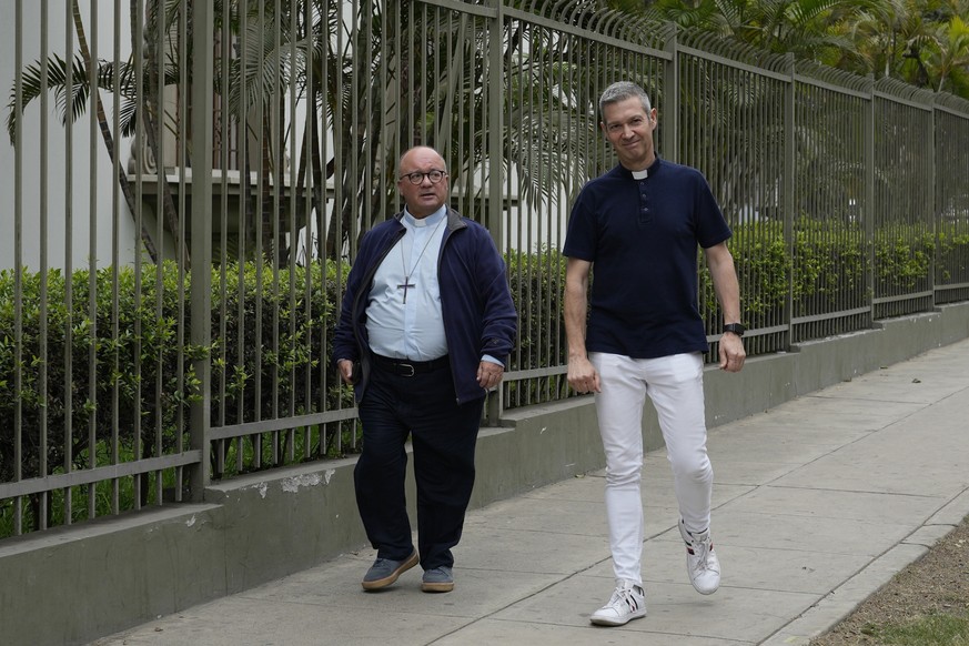 FILE - Vatican investigators Monsignor Jordi Bertomeu, right, from Spain, and Archbishop Charles Scicluna, from Malta, walk outside of the Nunciatura Apostolica during a break from meeting with people ...