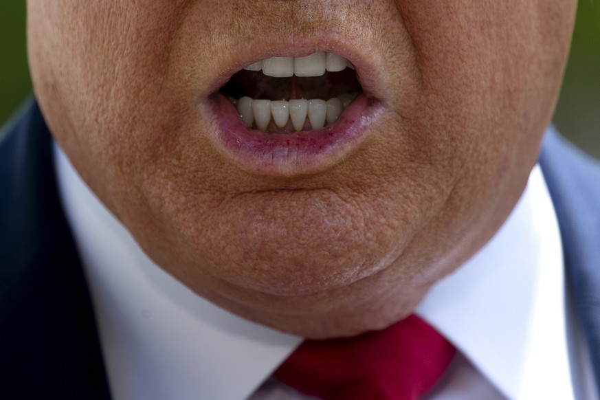 FILE - In this May 30, 2020, file photo, President Donald Trump speaks with members of the press on the South Lawn of the White House, in Washington. Reports of hateful and violent speech on Facebook  ...