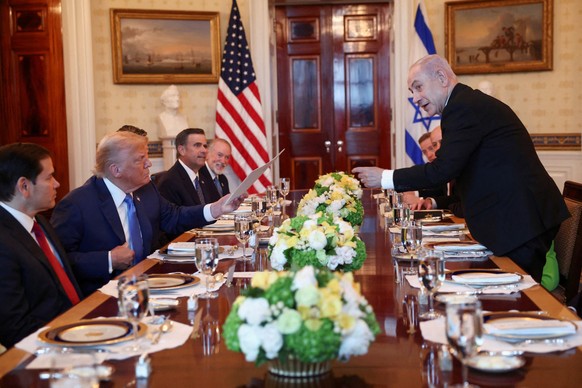 U.S. President Donald Trump receives a nomination letter after Israeli Prime Minister Benjamin Netanyahu told him he nominated him for the Nobel Peace Prize, during a bilateral dinner, with U.S. Defen ...