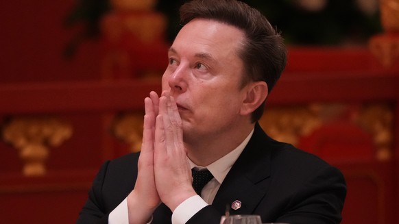 Elon Musk listens to the speech of Chinese President Xi Jinping during a state dinner with President Donald Trump at the Great Hall of the People on Thursday May 14, 2026, in Beijing. (AP Photo/Mark S ...