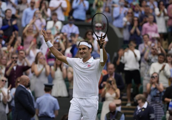 Switzerland&#039;s Roger Federer celebrates winning the men&#039;s singles third round match against Britain&#039;s Cameron Norrie on day six of the Wimbledon Tennis Championships in London, Saturday  ...
