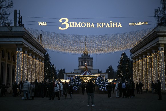 Attendees stroll through the National Expocenter of Ukraine VDNG during the opening of the eleventh season of the Winter Country Christmas location in Kyiv, Ukraine, on November 29, 2025 Photo by Yevh ...