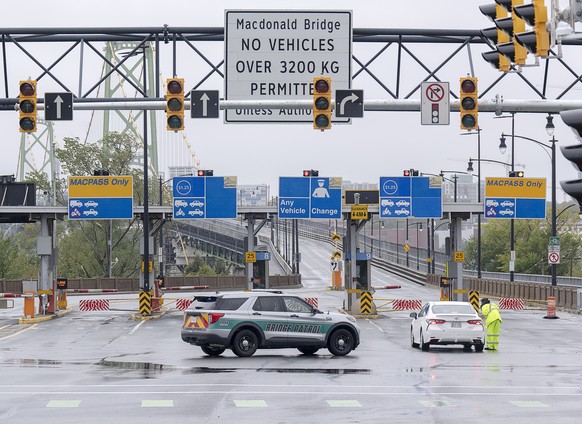 Police block lanes of traffic as both Halifax harbor bridges were closed in Dartmouth, N.S. on Saturday, Sept. 24, 2022. Strong rains and winds lashed the Atlantic Canada region as Fiona closed in ear ...
