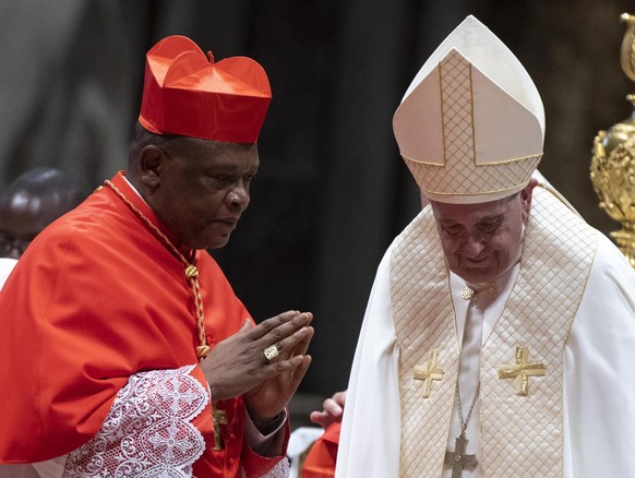 epa12046309 (FILE) - Pope Francis with Archbishop of Kinshasa, Fridolin Ambongo Besungu, during the ordinary public Consistory for the creation of new Cardinals in Saint Peters Basilica at the Vatican ...