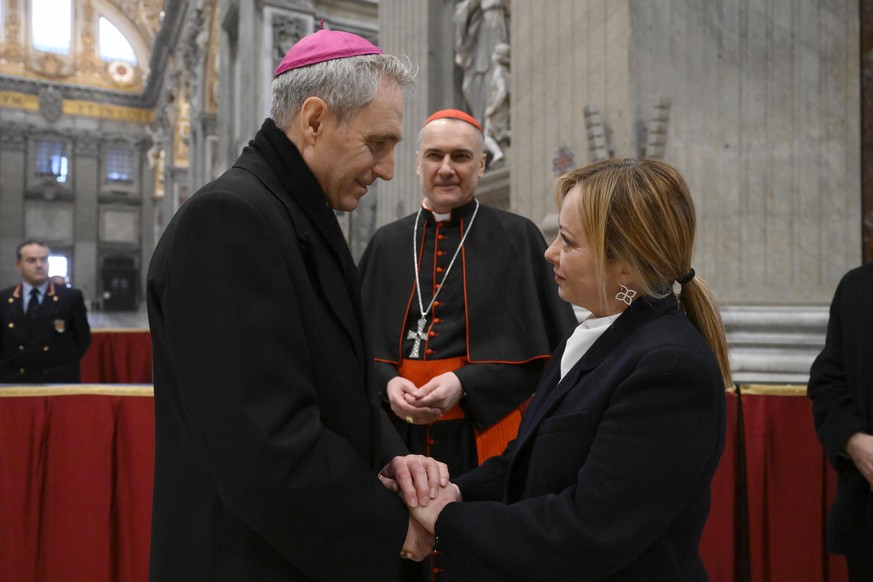 epa10386145 A handout photo made available by Vatican Media shows Italian Prime Minister Giorgia Meloni greeting Archbishop Georg Gaenswein as they pay respects to late Pope Emeritus Benedict XVI (Jos ...