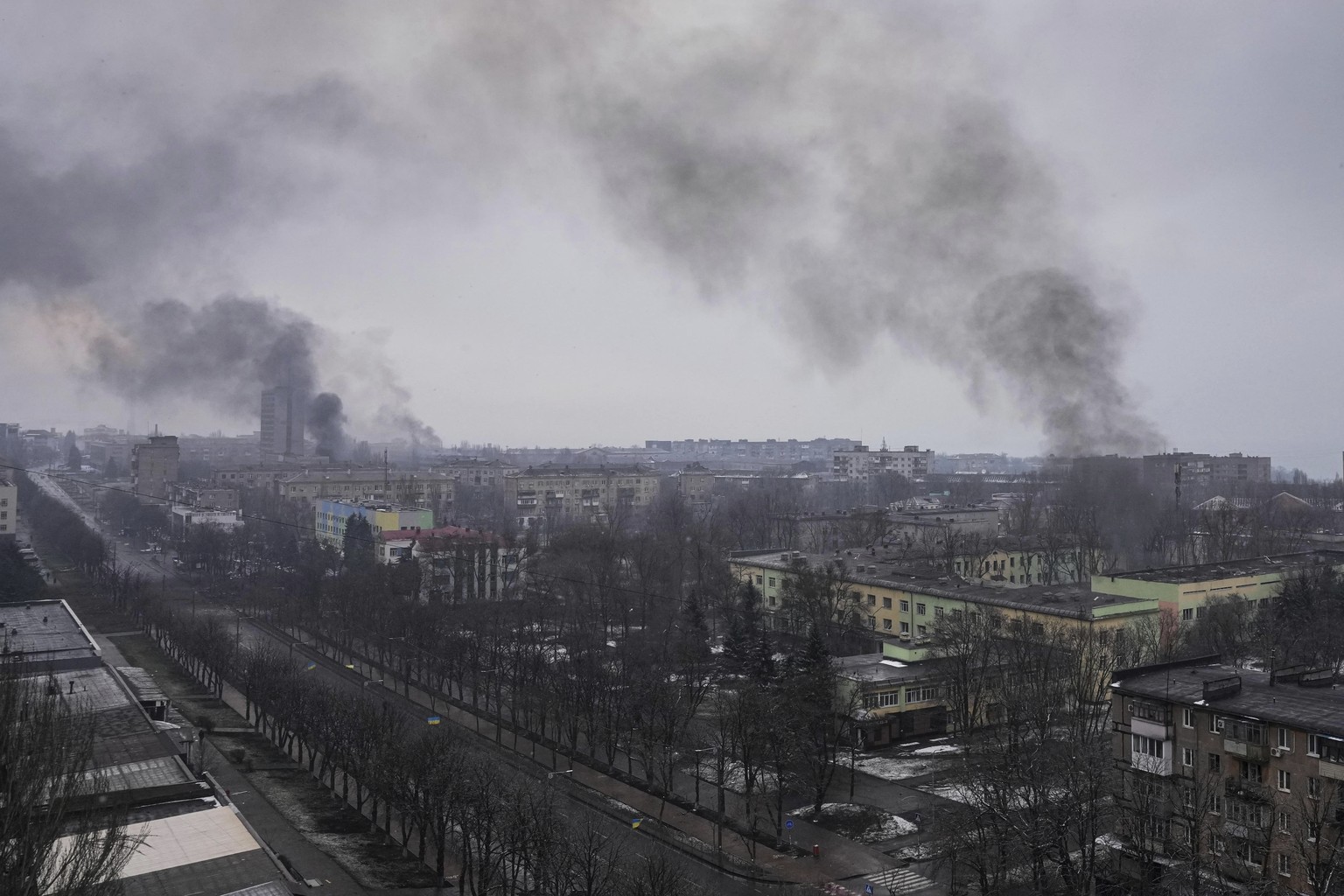 FILE - Smoke rises after shelling in Mariupol, Ukraine, March 9, 2022. An Associated Press team of journalists was in Mariupol the day of the airstrike and raced to the scene. Their images prompted a  ...