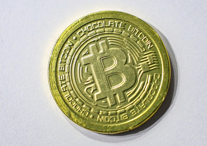 epa12891658 A chocolate Bitcoin coin is seen during the Blockchain Forum 2026 in Moscow, Russia, 15 April 2026. The Blockchain Forum is the largest crypto forum and exhibition on Web3, mining, cryptoc ...