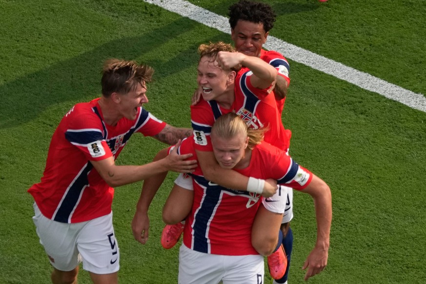 Norway's Erling Haaland (9) is mobbed by teammates after scoring their first goal during the World Cup round of 16 soccer match between Brazil and Norway in East Rutherford, N.J., near New York,  ...