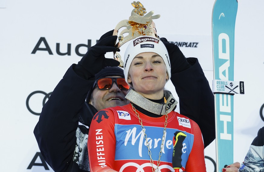 Italian ski legend Alberto Tombs places a crown on the head of Switzerland's Lara Gut Behrami after she won an alpine ski, women's World Cup giant slalom, in Kronplatz, Italy, Tuesday, Jan.  ...