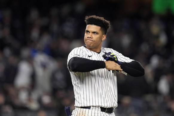 New York Yankees&#039; Juan Soto takes off his batting gloves after grounding out against the New York Yankees to end the third inning in Game 3 of the baseball World Series, Monday, Oct. 28, 2024, in ...