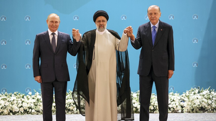 Russian President Vladimir Putin, from left, Iranian President Ebrahim Raisi and Turkish President Recep Tayyip Erdogan, pose for a photo prior to their talks at the Saadabad palace, in Tehran, Iran,T ...